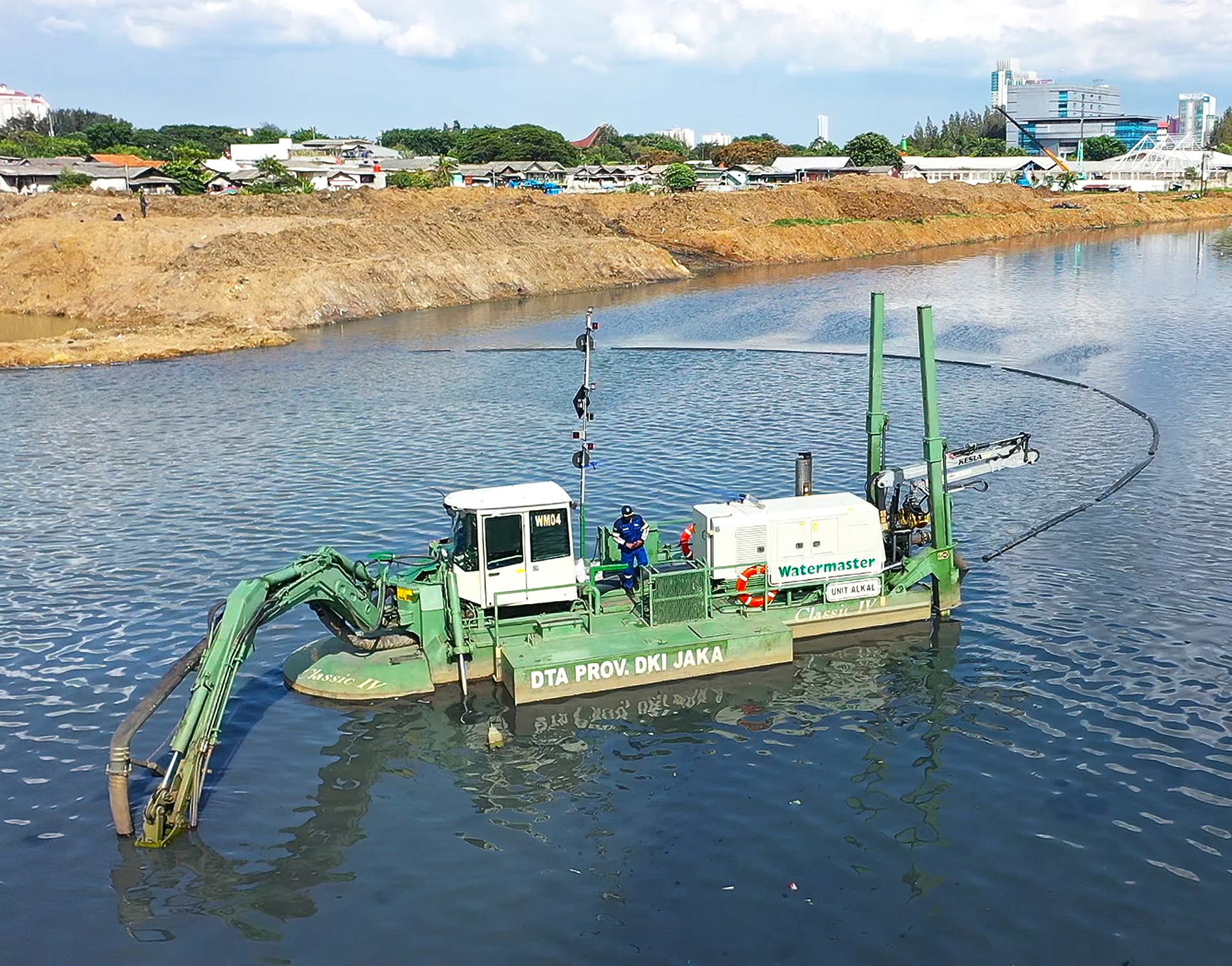 Watermaster dredging accumulated silt from urban water bodies to improve flow and prevent flooding